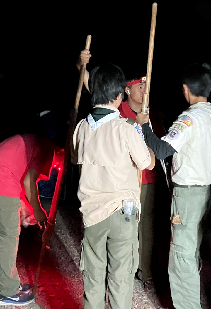 Scouts building the 1.5 stick long camp gate edges