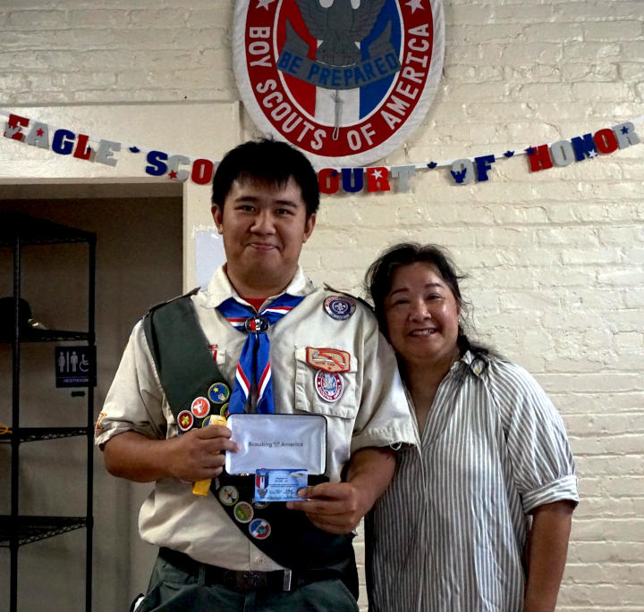 New eagle scout holds award