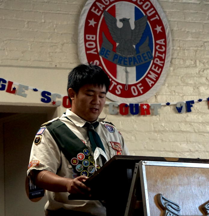 New eagle scout stands at a podium and makes a speech