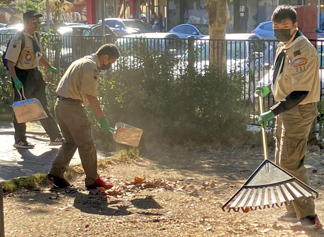 Three volunteers finish removing leaves