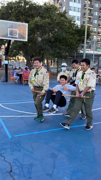 Person being carried in an A frame by four other people /images/townnight/IMG_9585.jpg