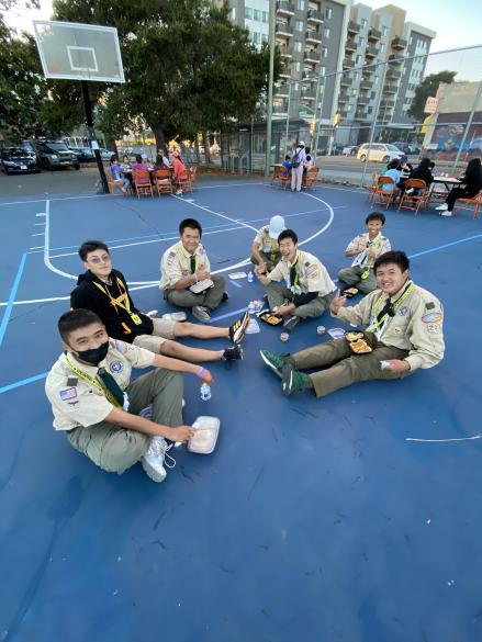 People sitting in a circle on a basketball court /images/townnight/IMG_9592.jpg