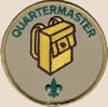 Quartermaster badge: the word quartermaster, a yellow backpack, and a small trefoil